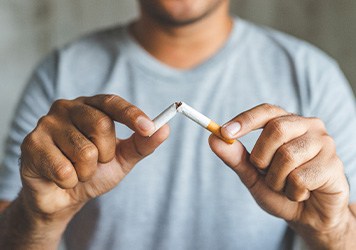 Closeup of patient breaking cigarette