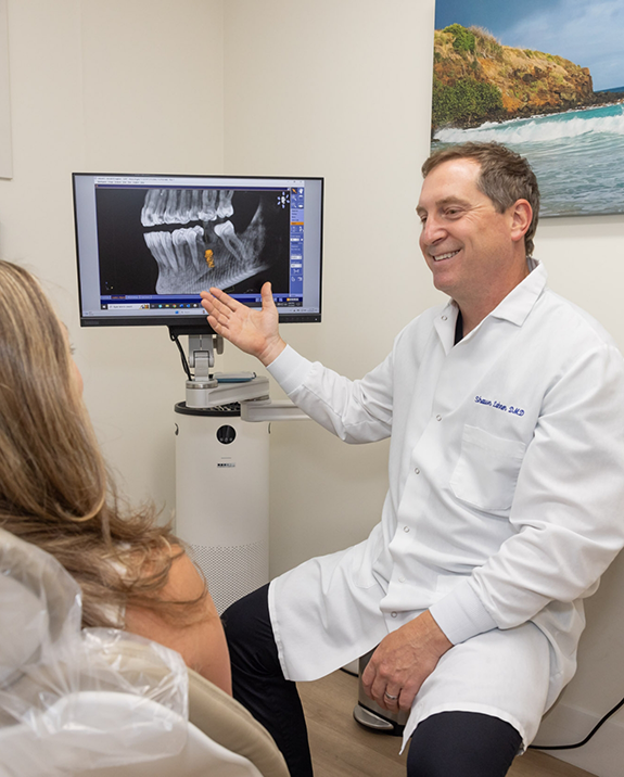 Dentist showing a patient an x ray of their teeth