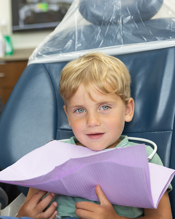 Young blond boy sitting in the dental chair