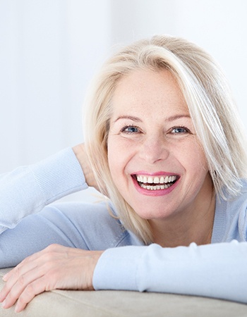 An older woman with dental implants in Ellington smiling.