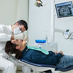 Implant dentist in Ellington performing exam on a patient