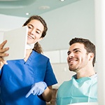 Dentist explaining cost of dental implants in Ellington to patient