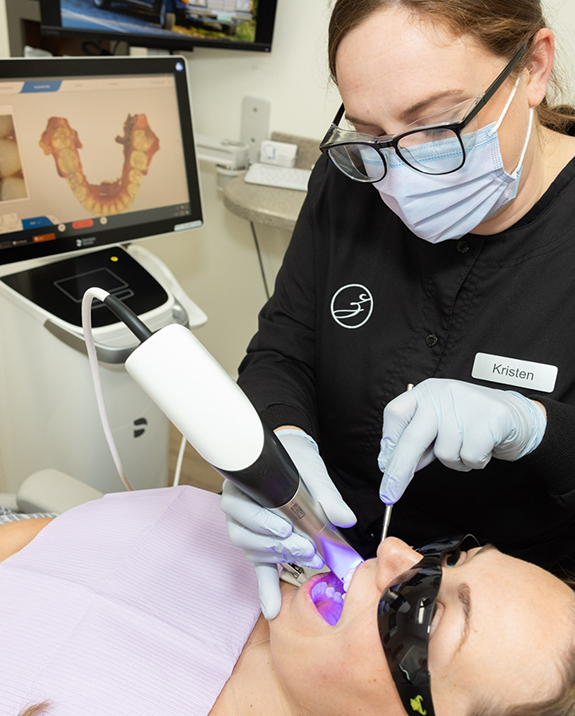Dental team member capturing digital scans of a patients teeth