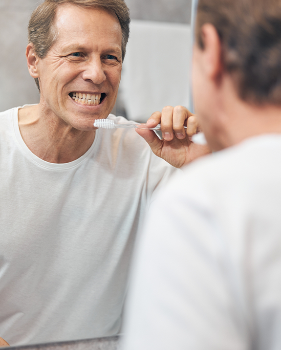 Man brushing his teeth at home