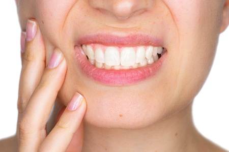 Close up of woman’s smile in pain