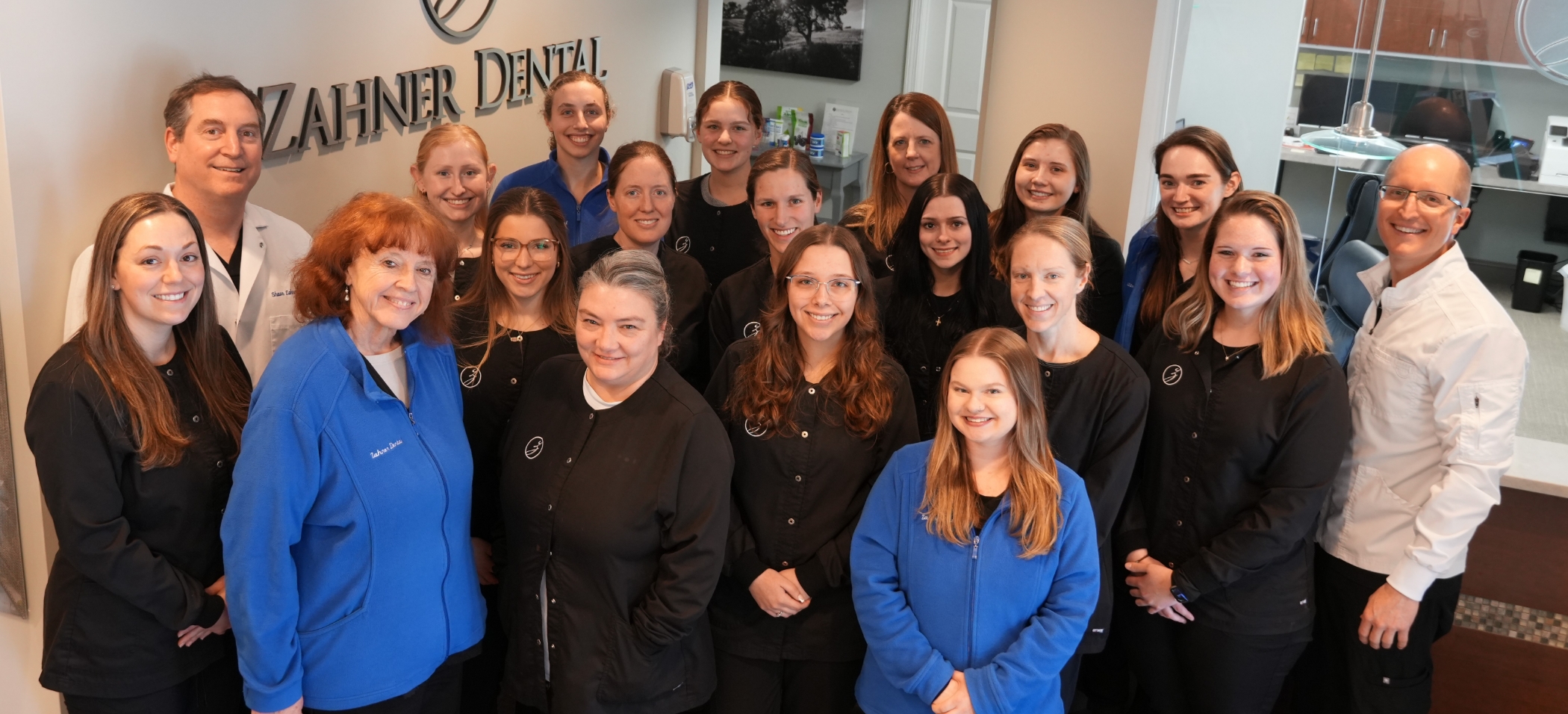 Group photo of the Ellington dentists and team members at Zahner Dental in a field