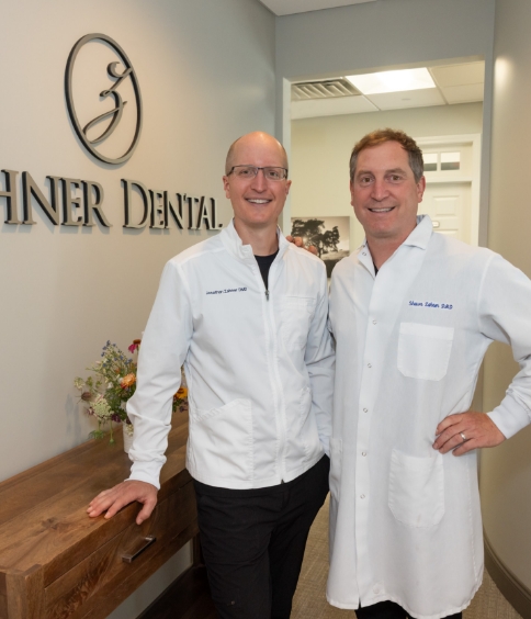 Ellington dentists Doctor Jonathan Zahner and Doctor Shawn Zahner smiling in white lab coats