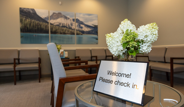 Tablet just inside the entrance reading welcome please check in