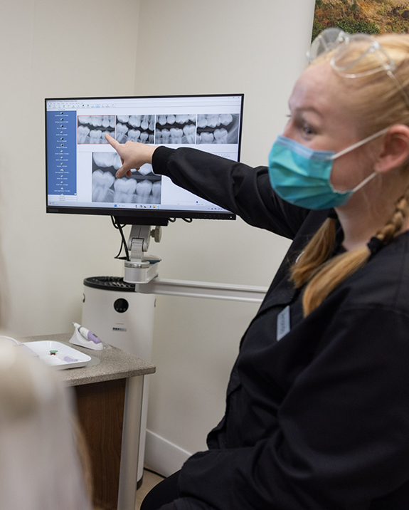 Dentist showing a patient an x ray of their teeth