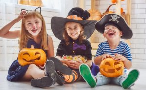 Children in costumes with candy.